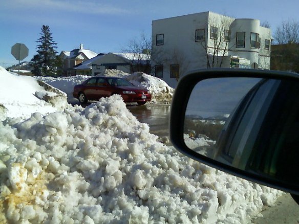 Take a look at these big piles of snow down the middle of the streets in town after the last blizzard. Views are pretty obstructed at the intersections!